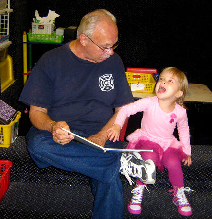 Gianna Damiano and Grandpa Damiano read a silly book for a good laugh together.