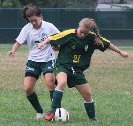 Lynbrook's Meghan Montine, right, tries to maintain possession with Valley Stream North's Alyssa Franco on her heels.