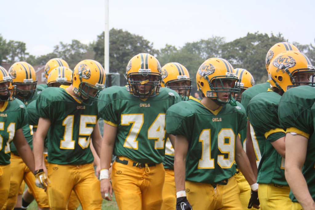 The Lynbrook High School Varsity Football team created an imposing image marching onto the field.