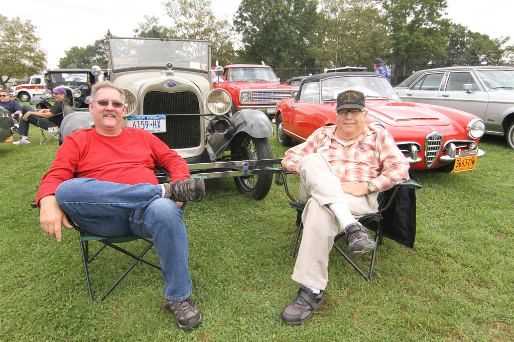 Michael Beebe and Bruce Stegner enjoy the day seated in front of a 1929 Model A Roadster.