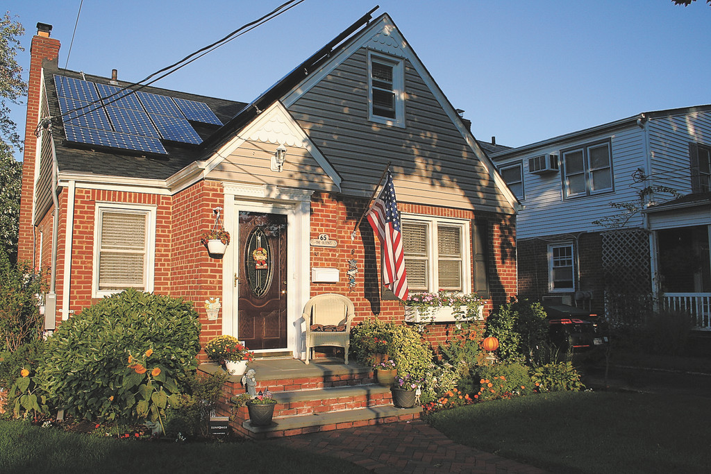 his Lynbrook home, left, gets its electric power from solar energy.