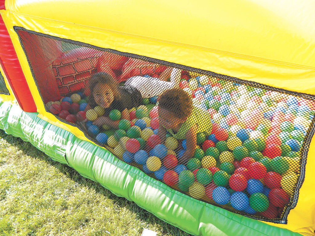 Sisters Amira, 5, left, and Mya Royer, 1, played in the ball-pit of an inflatable bounce house.