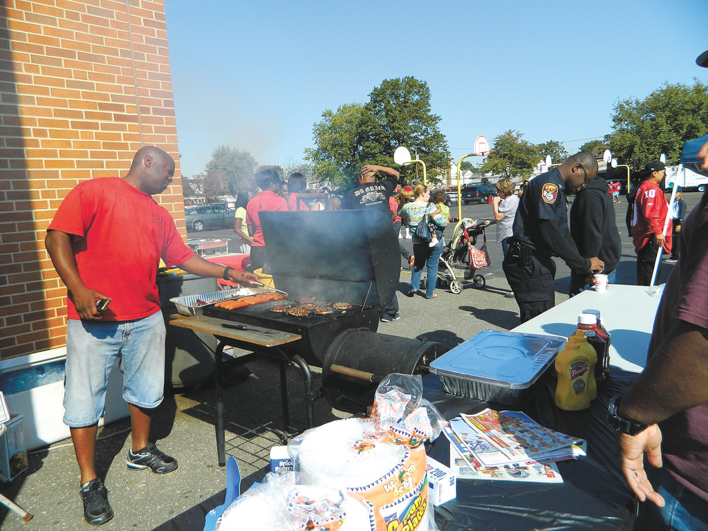 John Watkins, left, was the cook at the Elmont Cardinals Sports Club’s Family Fun Day, held on Oct. 8.