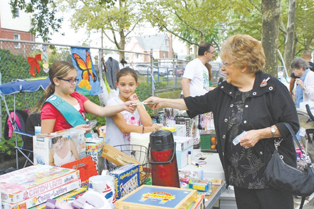 Junior girl scouts Christina Falcone, 10, left, and Hannah Condia, 10, of Troop 1272 made several sales on Oct. 1.