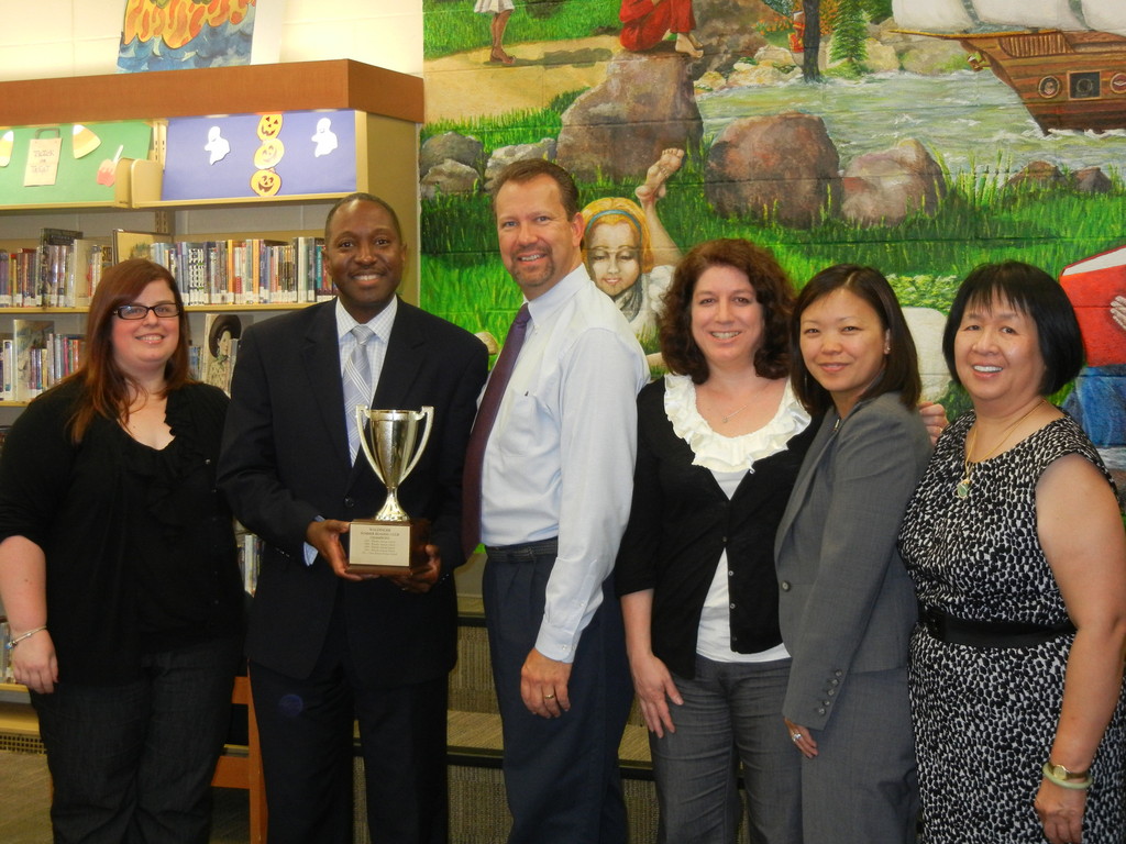 Clear Stream Avenue school won this year’s Waldinger Cup. From left are children’s librarian Jaclyn Kunz, Principal John Singleton, Mayor Ed Fare, school librarian Carolyn Kaiser, Assistant Principal Yannie Chon and library Director Mamie Eng.