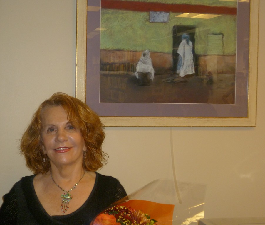 Gilda De Lio stands by one of her works of art inspired by real-life events.