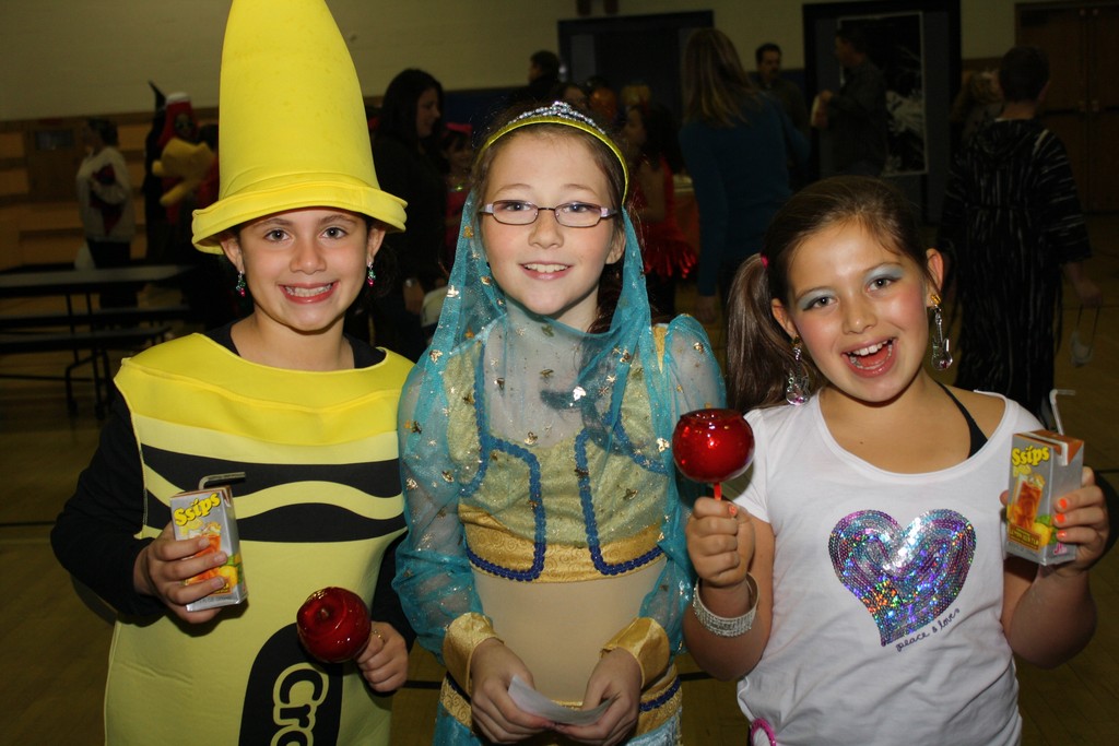 Adriana Marchetti, 9, from left; Kayla Kessler, 10; and LizAlexia Papadoniou, 10, were all smiled at the John Street spooky dance last Friday.