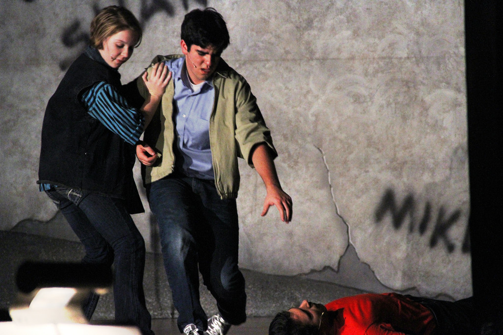 After stabbing Bernardo (Zack Zaromatidis), Anybodys (Siobhan Connor) pulls Tony (Thomas Lynch) away from the scene.