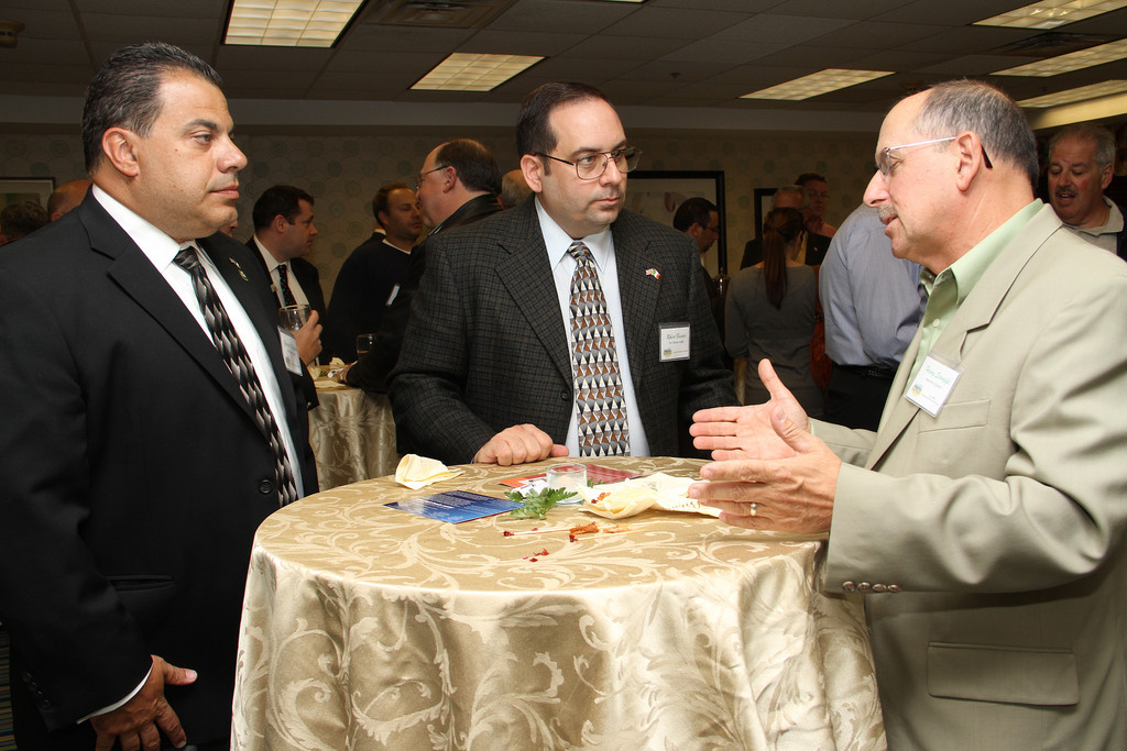 Gerardo Filippone, left, and Robert Baccari, both of Lynbrook’s Sons of Italy Per Sempre Membership Committee, chat with Henry Stempfel of Malverne.