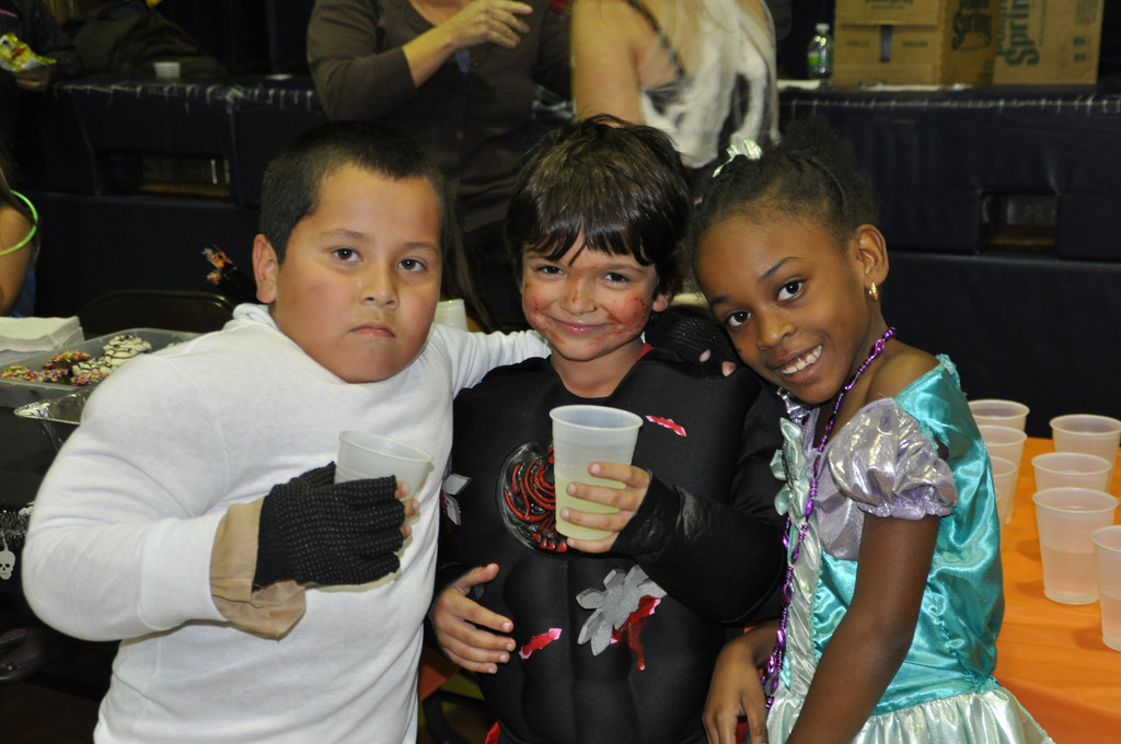 Covert Avenue students Anthony Osorio, left, Daniel Denehy and Dayna Marston were all smiles at the Covert Avenue School's Halloween party.