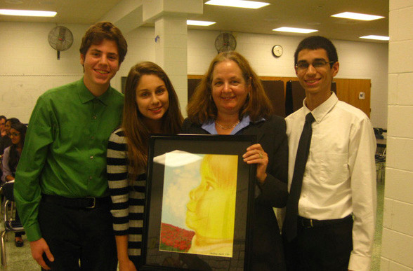 High School Board President Jeanne Greco Jacobs, second from right, holds an artistic painting, given to the board by North High School. Presenting the piece of art were, from left, Student Council Vice President Andrew Jacobs, Secretary Christina Cinnamo and President Charles Sanky.