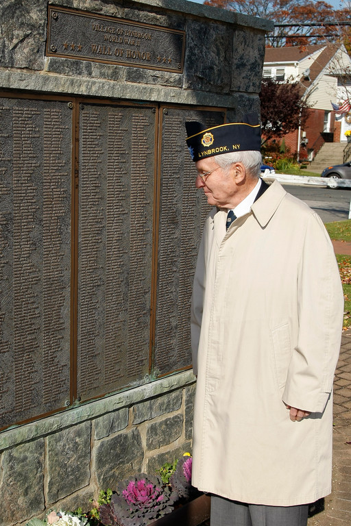World War II veteran Fracncis X. Becker looks at the names of comrades on the Lynbrook Wall of Honor.