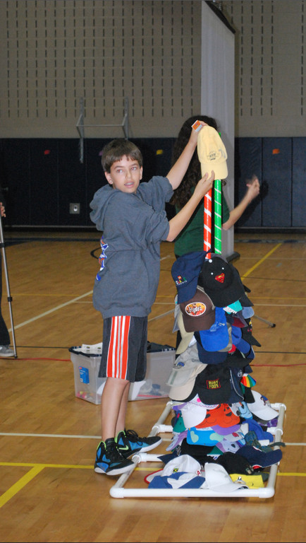 Woodmere Middle School eighth-grader Mason Fliesel placed a hat on a pole during the “Stack the Caps” assembly.