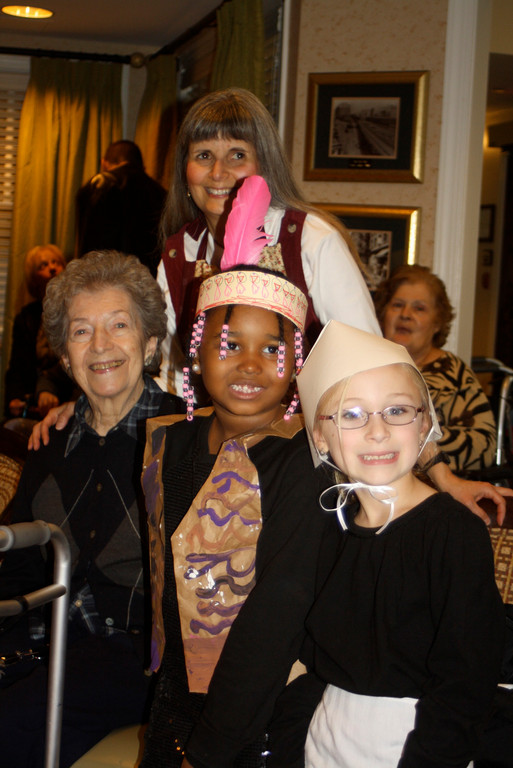 At the conclusion of the show,  West End Music teacher Stella Kruh, standing, and first graders Breyelle Corvoisier and Christina Wesner visited with resident Dilma Stagnoli.