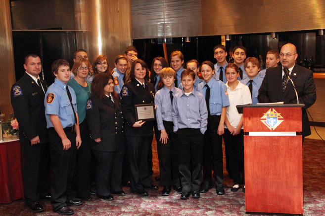 Kiwanis President Carmine Tufano, far right, presented an award to the East Rockaway Fire Department Juniors.