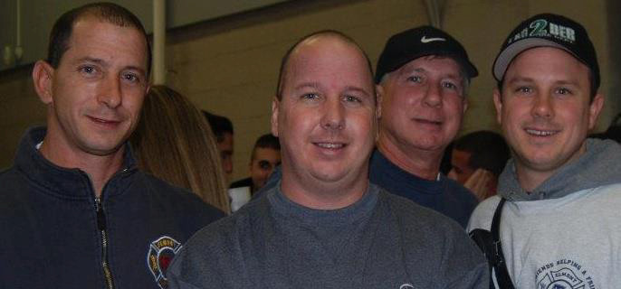 Richard Schriefer III, center, a Franklin Square resident and ex-chief of the Elmont Fire Department, discovered he had brain cancer last summer. He is now battling the disease with help from his firefighter family: his brother, Elmont F.D. Captain Robert Schriefer, left; his father, Richard Schriefer Jr.; and his other brother, Third Assistant Chief Brian Schriefer.