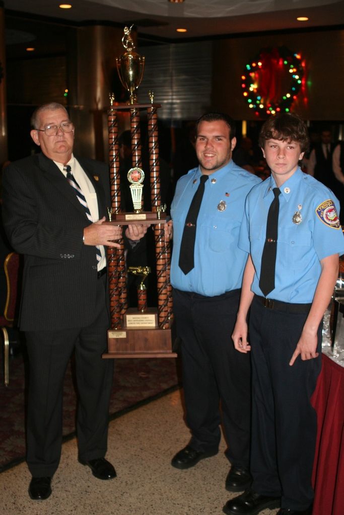 Thomas Fitzsimons of the Baldwin FD, and president of the Nassau County Drill Teams Captain’s Association, presented the Juniors first place trophy to Lynbrook Junior Captain Dylan Bien and Second Lieutenant John O’Reilly III.