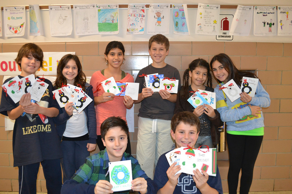 Fitfh graders at Waverly Park School  created “coraments,” holiday cards that double as ornaments, for their adopted solidier Lietenant Durso’s Platoon in Afghanistan. Pictured standing from left were Jason Holoquist, Jessica Gavzie, Chelsea Guevara, Brandon Pekale, Kaylie Hauskenecht and Miranda Zaransky. Kneeling from left were Harrison Glassman and Jesse Candel.
