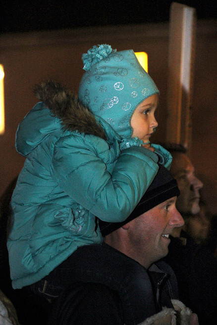 Lindsey Kupfer sits perched on her father, Chuck’s shoulders to get a better look at the festivities.