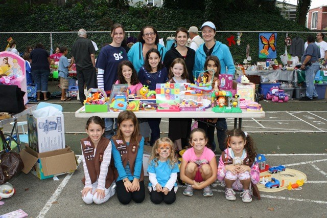 Brownie Troops 1753 and 1035 had booths at the sale. Pictured here are troop leaders Mary Ann Pelzer, left, standing, Filomena Carrini, Stacy Koehler and Anne Faglione; Lauren Faglione, 7, left, middle row, Nicole Faglione, 9, Annie Moore, 7, and Rosalia Logrande, 7; and Ava Pelzer, 7, from left, front row, Sydney Koehler, 6, Samantha Farrell, 3, Sydney Farrell, 7, and Isabella Carrini, 7.