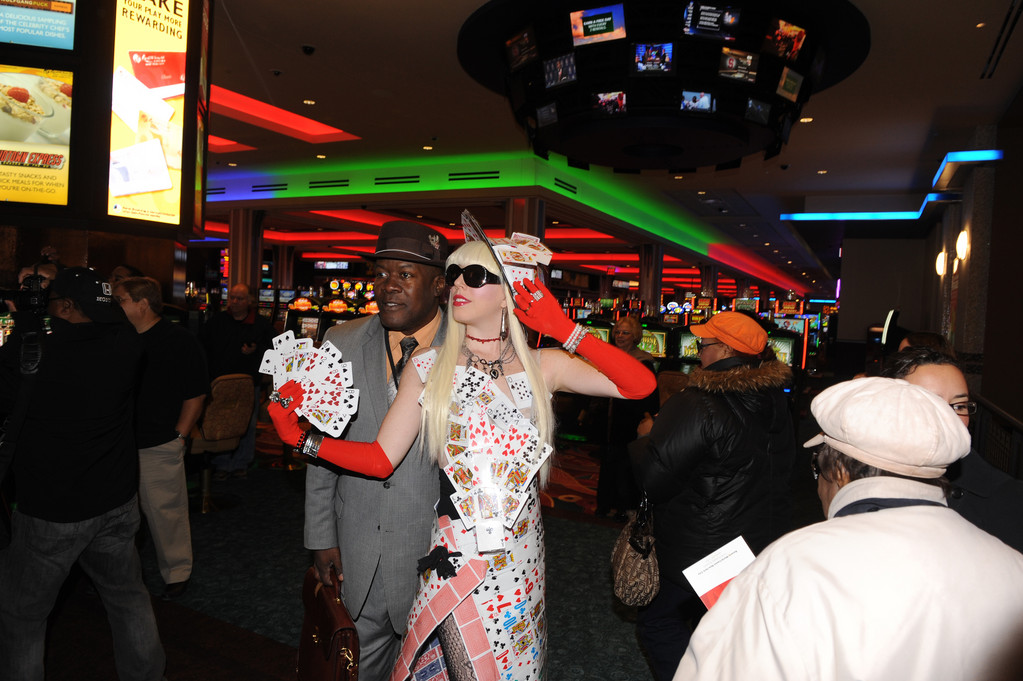 A performer showed cards to patrons of Aqueduct Racetrack's Resorts World Casino-New York on its opening day, Oct. 28.
