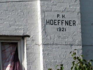 Philip Hoeffner died on March 30, 1929, in Elmont. Today, the only known documentation of him is on a plaque located on a white building on the corner of Hempstead Turnpike and Elmont Road in Elmont, pictured here; a plaque in the Elmont Union Free School District; and his tombstone, which is located in the St. Boniface Cemetery in Elmont.