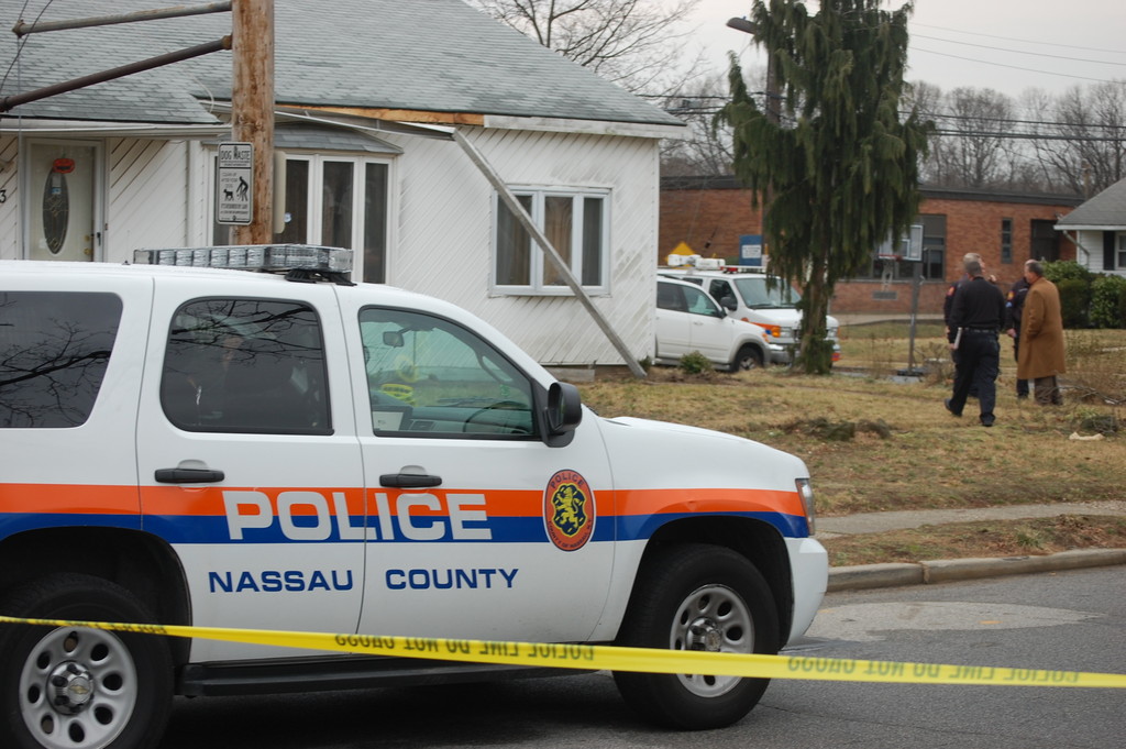Nassau County Police investigate the scene of a home invasion at the corner of Dana Street and Howell Road in North Valley Stream.