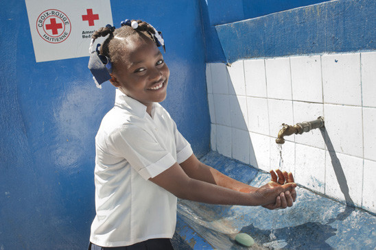 ALEXANDRA PIERRE, 13, washed up at a faucet that was recently installed at her school in Port-au-Prince with the help of the American Red Cross.