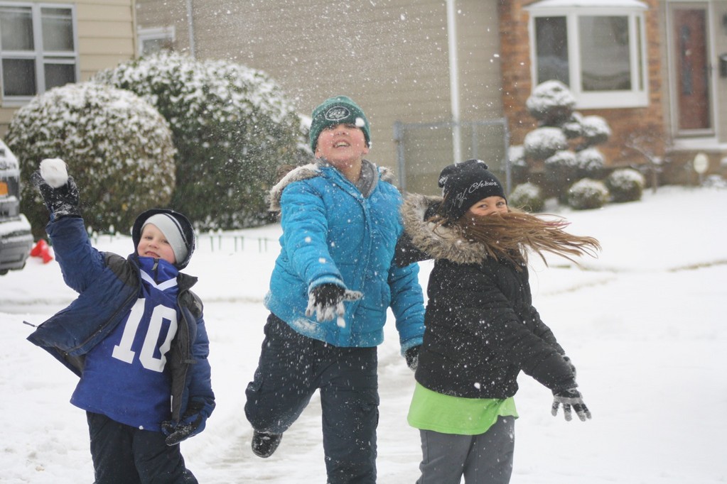 Franklin Square residents David Ras, 7, Caroline Ras, 10, and LizAlexia Papadoniou, 10, played in the snow on Saturday.