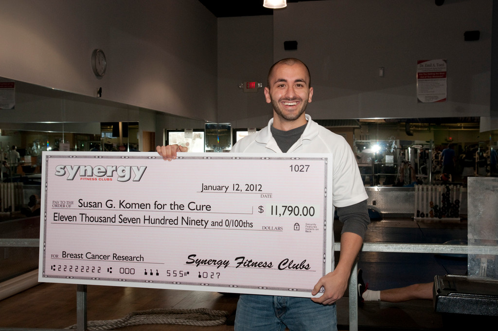 Rob Martinez, a manager at the Baldwin Synergy club, proudly held a check for Six local Synergy Fitness clubs recently collaborated to raise nearly $11,790 for Susan G. Komen for the Cure on Jan. 12.