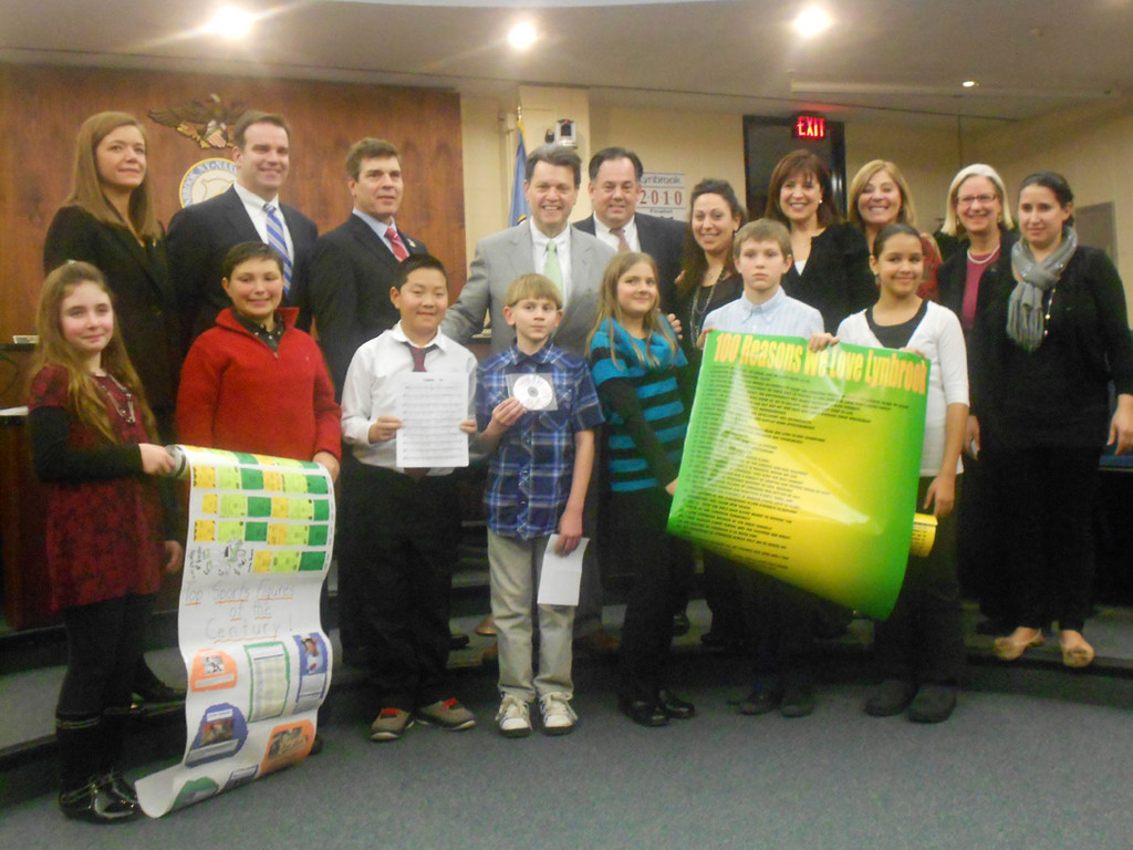 Residents, faculty and Village Board members on hand enjoyed students’ time capsule selections. Bottom row, from left, Allison Siegel, Griffin Kirby, Brandon Maroney, Jake D’Agostino, Katie Bamman, James Montgomery and Angelina Chirichella. Top row, from left, West End Principal Alison Puliatte, Trustee Thomas Atkinson, Deputy Mayor Alan Beach, Mayor Bill Hendrick, Trustee Michael Hawxhurst, Waverly Park teacher Shari Bowes, Waverly Park Principal Lucille McAssey, Rhonda Glickman, Marion Street Principal Barbara Moore and Marion Street teacher Jill Ra.