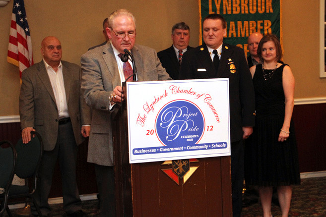 Fire Chief Michael Hynes, at right in uniform, was praised by Chamber president Bill Gaylor.