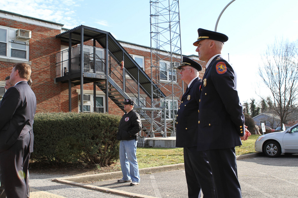 Police officers from the 5th Precinct stood watch today, as local residents rallied against Mangano's precinct plan.