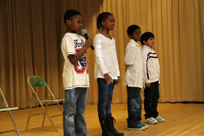 Fourth-graders Rickey Clarke, left, Folalse Famuyide, Alford Carbon and Xavier Quiroz said a few words about freedom during Gotham Avenue's afternoon assembly to celebrate Dr. Martin Luther King Jr.