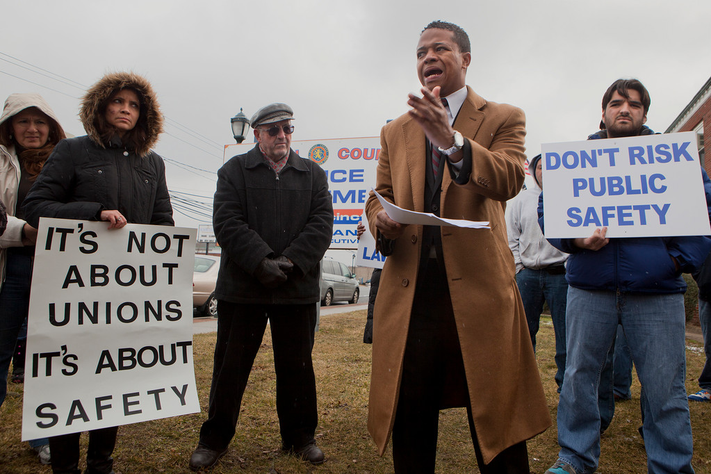 Congressman Carrié Solages (D-Elmont), front, stood with protesters during a rally held on Feb. 11, at the  5th Precinct in Elmont, in opposition of Mangano's precinct plan.