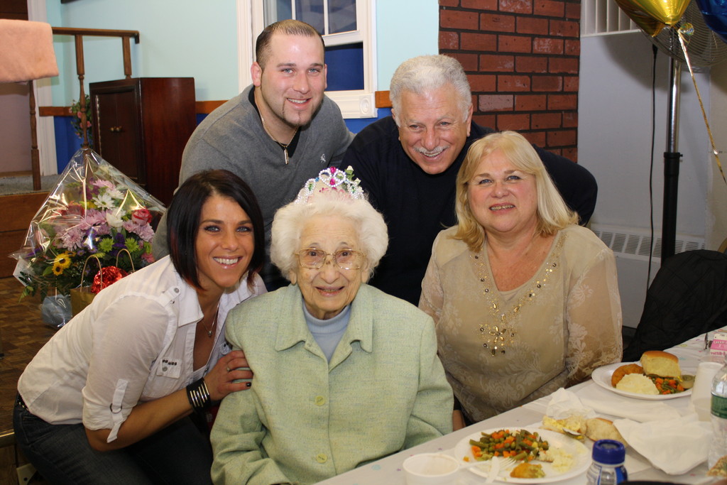 Mary Sesso, center, 105, with her grandchildren, Valerie, left, and Mario II; son, Mario, and daughter-in-law, Aileen.