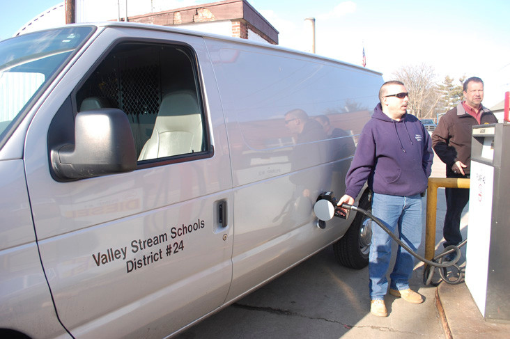 District 24 maintenance supervisor Charles Brocher, joined by Mayor Ed Fare, uses the gas pumps at the village’s public works facility on Arlington Avenue.