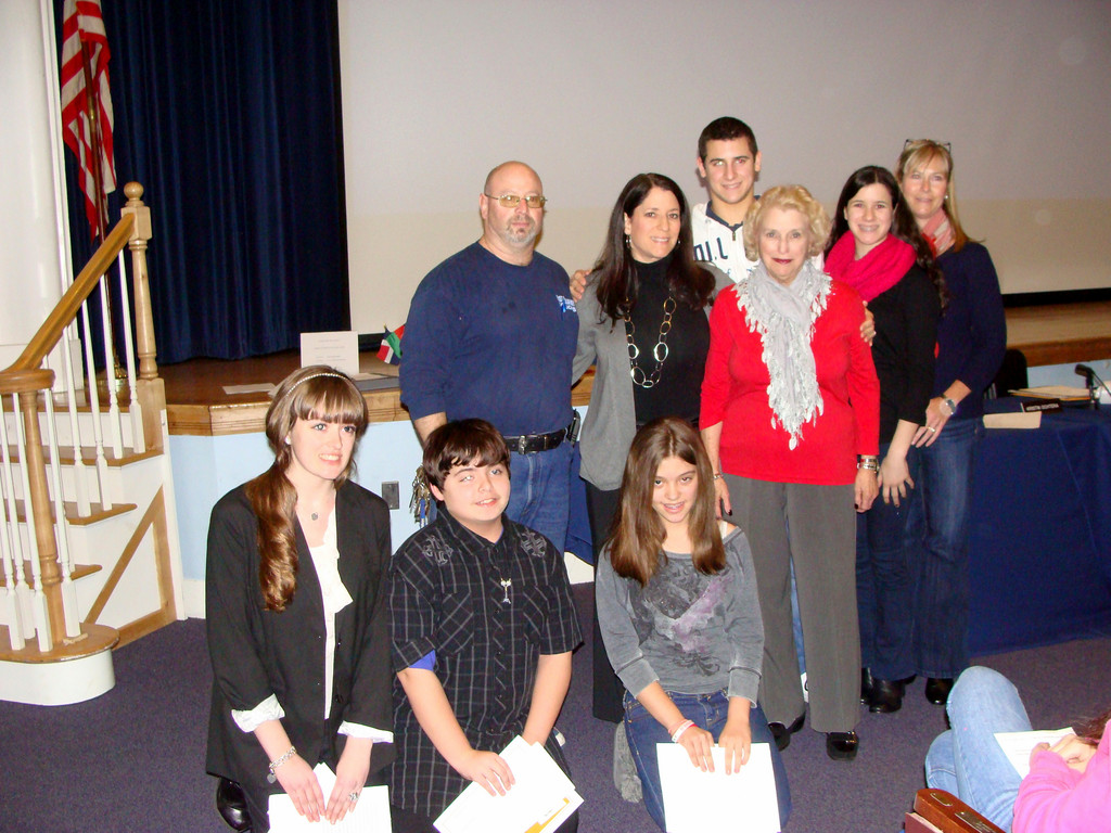 The Stern family congratulated the winners of the Andrew J. Stern Memorial Essay Contest. The family, standing from left are Andrew’s siblings Michael Stern and Lisa Burch; Andrew’s son, Danny, 18, his mother, Barbara, his daughter, Emma, 14 and his wife, Katie. Seated from left are essay winners Taylor Clarke, John Parenti and Joanna Ambrosio.