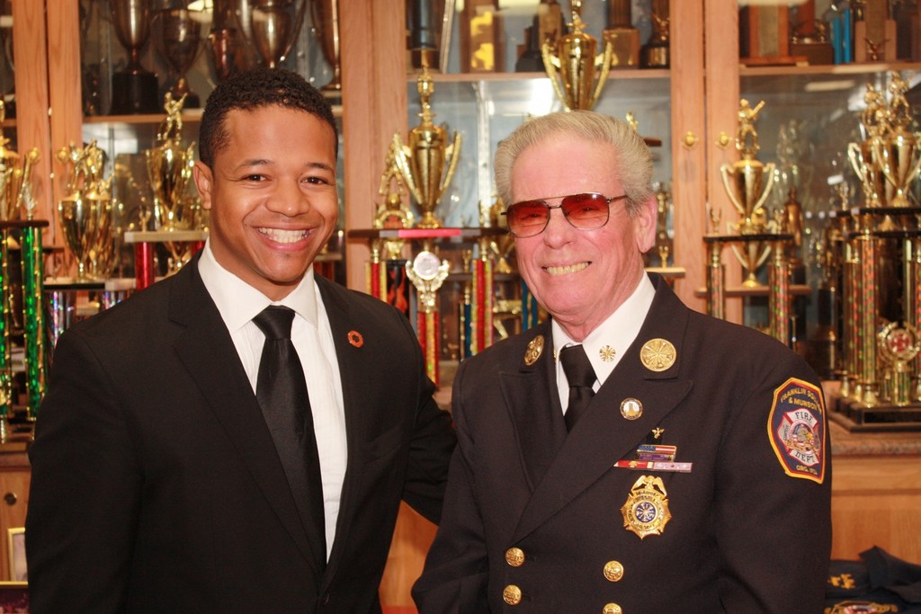 Nassua County Legislator Carrié Solages, left, congratulated Franklin Square-Munson Fire Department past chief Roger Albergo for his 50 years of service to the community.