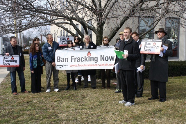 Sam Bernhardt, right, front, of Food and Water Watch, spoke to attendees of a rally to ban fracking last week, in front of Sen. Jack Martins's district office in Garden City Park.