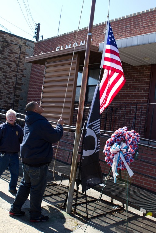 Local veterans Ralph Esposito, left, past-commander of the American Legion Post 1033, and Carl Achille, owner of The Shop in Elmont, raised a new flag at the VFW Post 455 building on Feb. 20.
