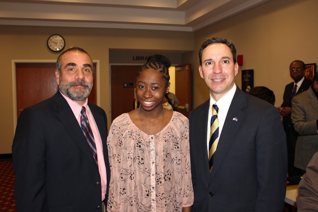 Elmont Memorial High School Principal John Capozzi, left, and Sen. Jack Martins, right, congratulated Rebecca Fortune of Elmont for winning the Adelphi University Award during the Black History Celebration.