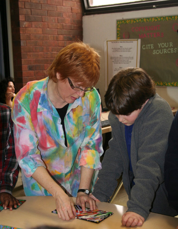 Woodmere artist Alli Berman worked with fifth-grader Aiden Samuels on connecting various pieces of puzzle art during the workshop.