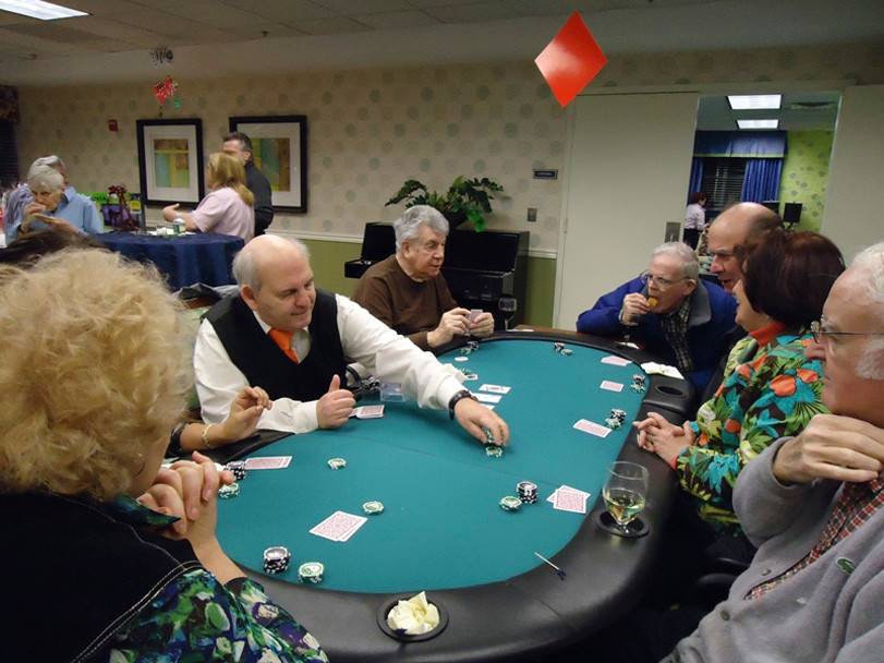 Resident Bill Sweeney,far left, watches the dealer.