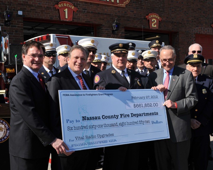 Floral Park Mayor Tom Tweedy, left, Nassau County Executive Ed Mangano, Nassau County Fire Commission Commissioner Richard Gardener and Sen. Charles Schumer posed with the $661,852 check from FEMA on Feb. 27.