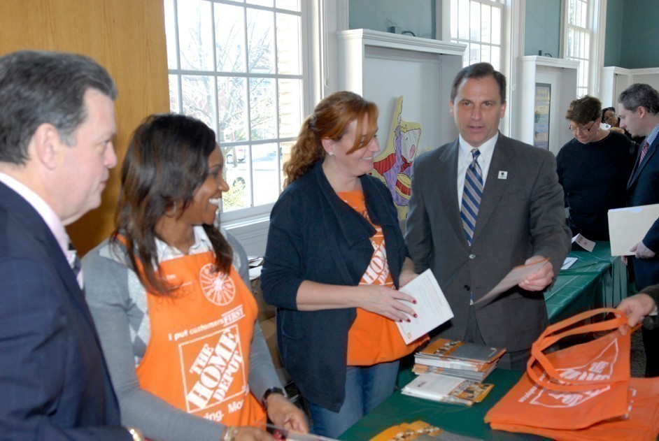 Mayor Bill Hendrick, left, and Trustee Hilary Becker talk with The Home Depot employees.