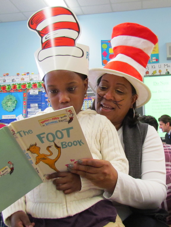 Alden Terrace first grader Grace Toussaint read Dr. Seuss’s “The Foot Book” to Alden Terrace Principal Amy Buchanan during the school's Dr. Seuss celebration.