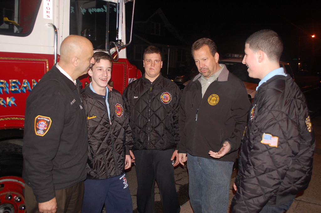 Mayor Ed Fare, second from right, talks about the new fire truck with Department Chief Joseph Fernandez, left, and junior officers Brendan Labeck, Peter Laserinko and Richie Field.