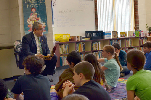 Councilman Anthony Santino reads to the students.