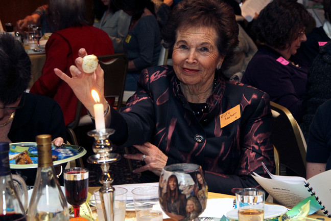 Ruth Haber holds up an egg at the Women's Seder.